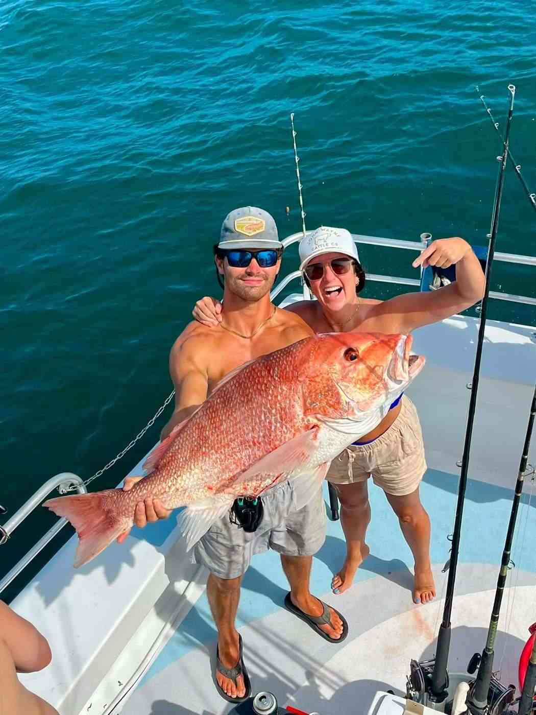 Two anglers with a big red snapper on the stern, Orange Beach Alabama