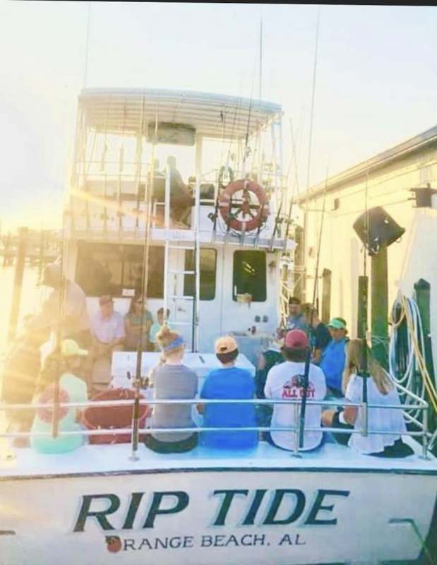 Anglers aboard the Rip Current at the dock in morning light