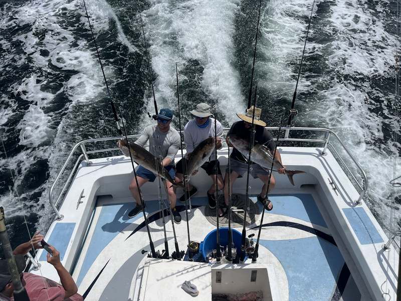 Anglers working the rods on the back deck as the Rip Tide trolls offshore
