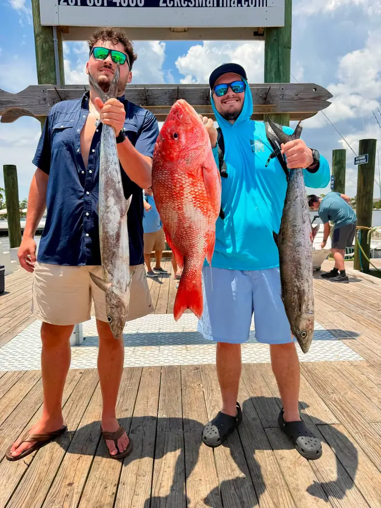 Two anglers with a red snapper and a big cobia