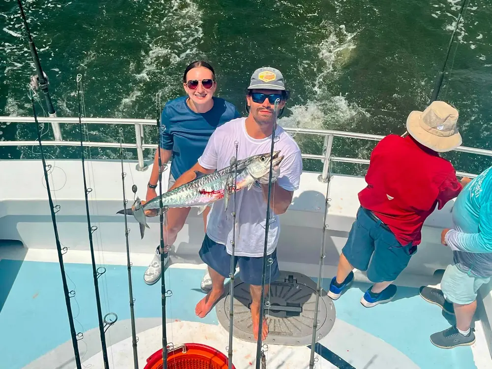 Guests with their catch on the back deck of the boat