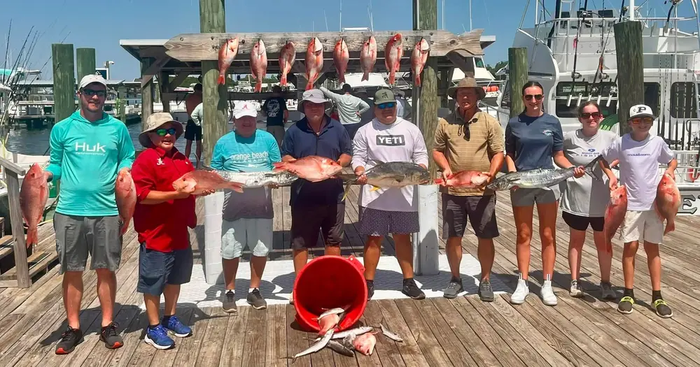 A big charter group with their snapper at the fish rack