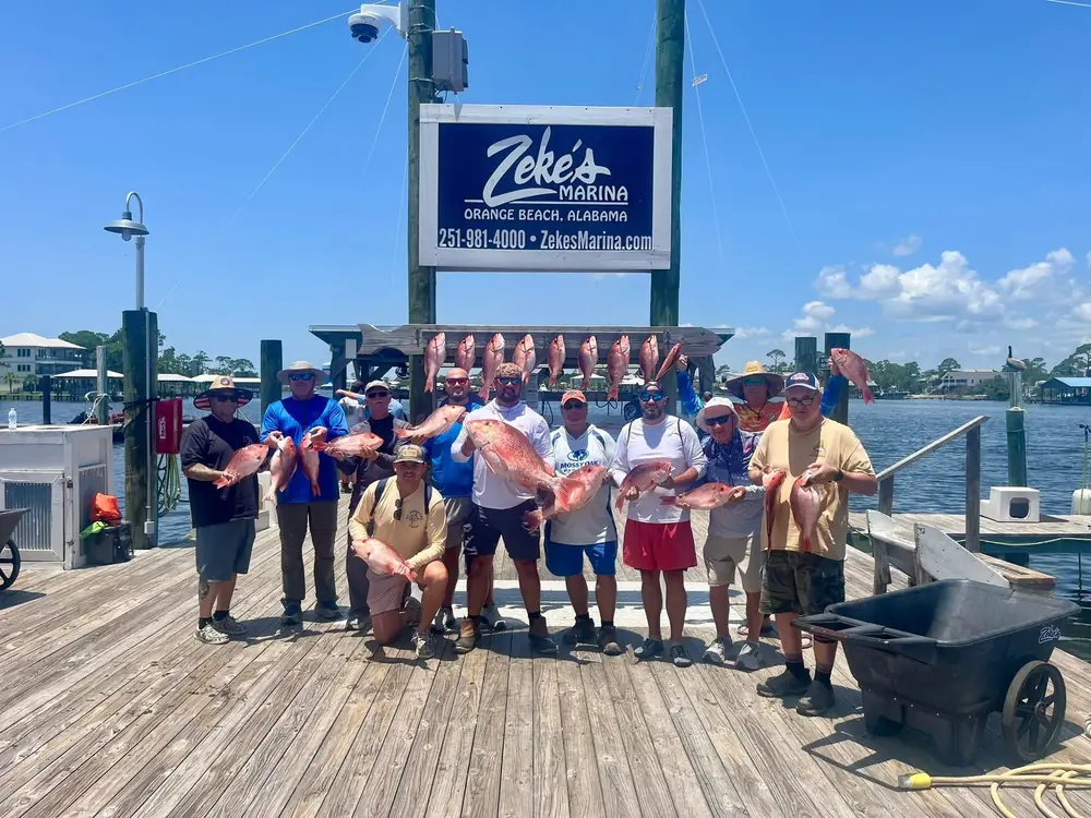 A charter group under the Zeke's Marina sign in Orange Beach