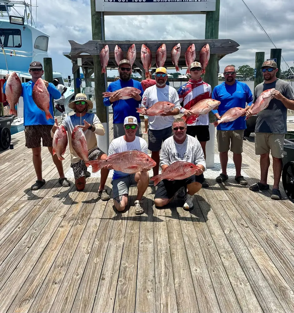 A group of guests kneeling with their red snapper