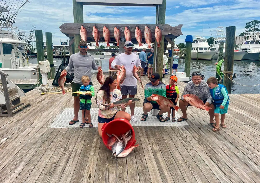 Young anglers with their red snapper on the dock