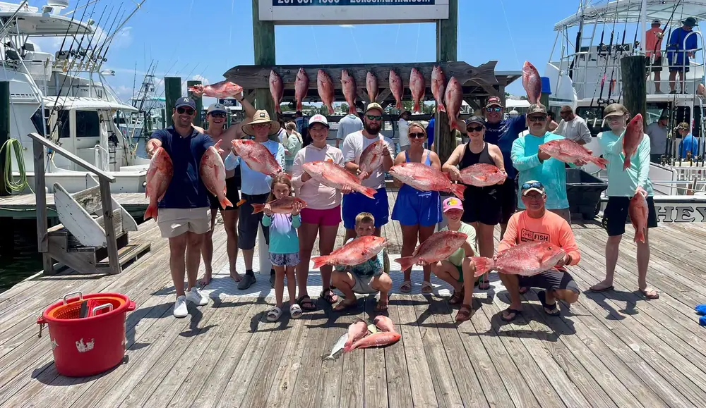 A big group charter with their snapper at the fish rack