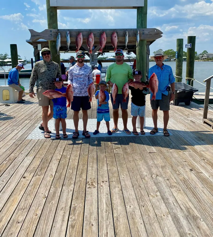 A charter group with their catch on the Orange Beach dock