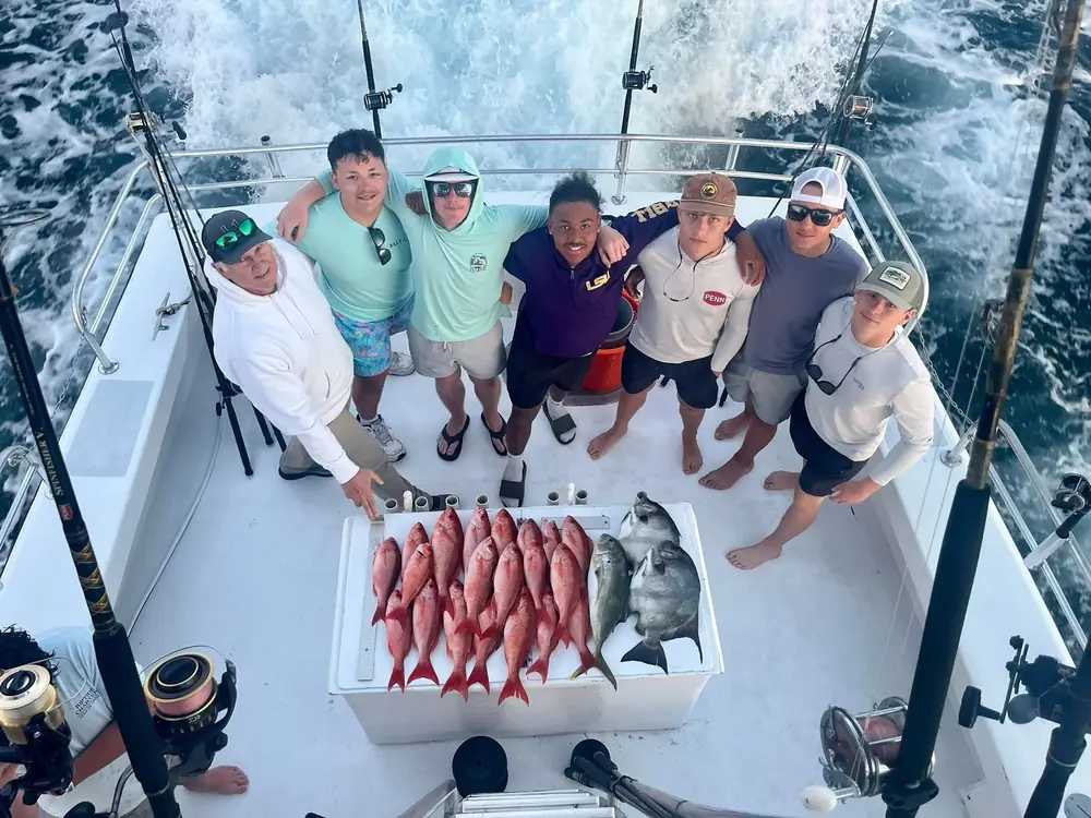 Guests aboard the boat with the day's snapper laid out