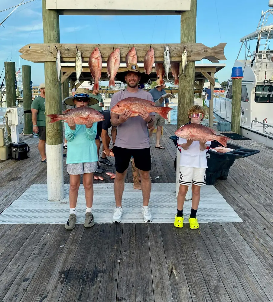 Kids and parents with their red snapper at the marina