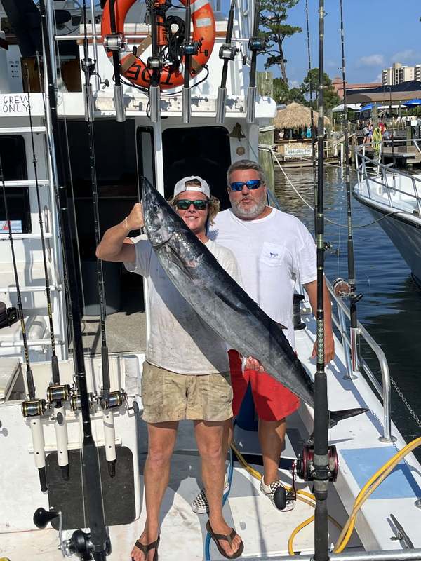 Anglers with a wahoo landed on the back deck of the Rip Tide