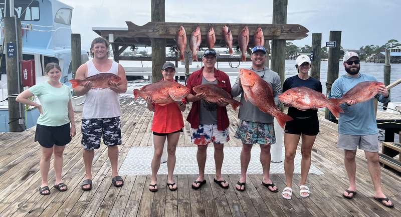 Anglers lined up with red snapper on the Orange Beach dock