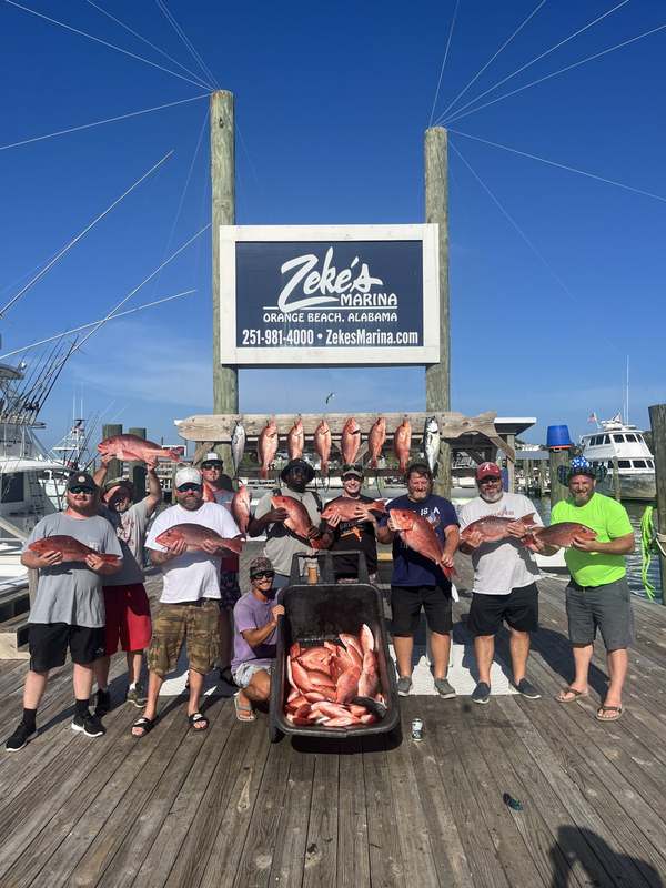 A large charter party with their snapper at the dock