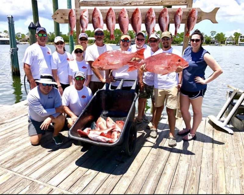 A charter group with red snapper on the Orange Beach pier