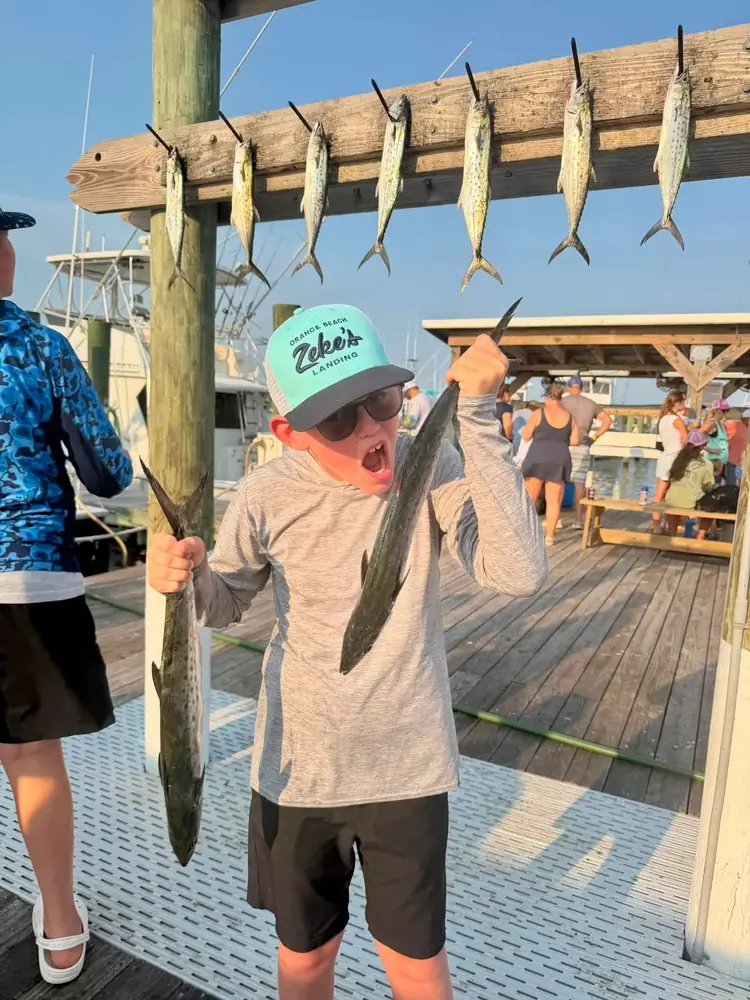 An angler with a long wahoo taken trolling offshore