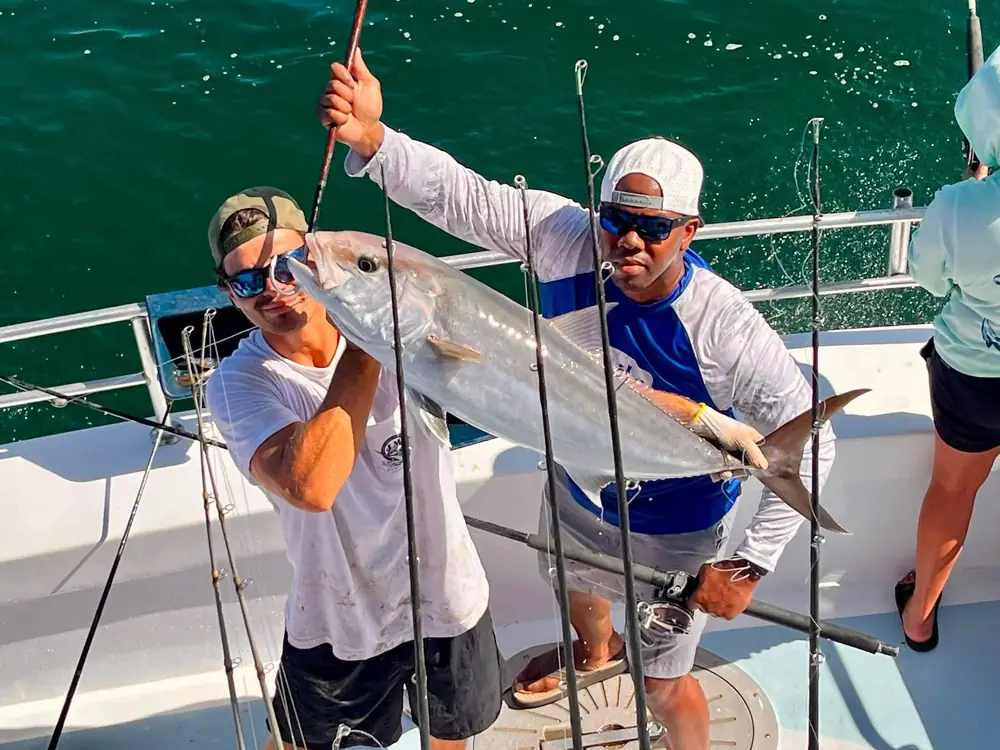 Anglers with a king mackerel on the back deck