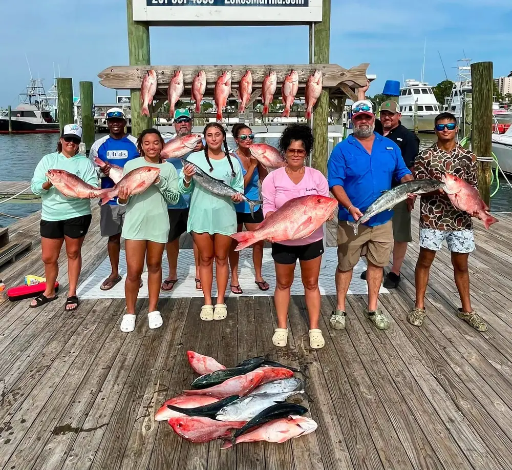 A charter group with their snapper catch under the rack