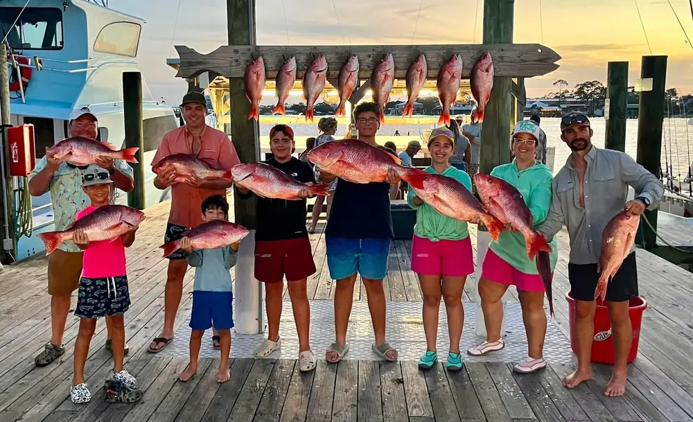 A family charter with their catch at the fish rack