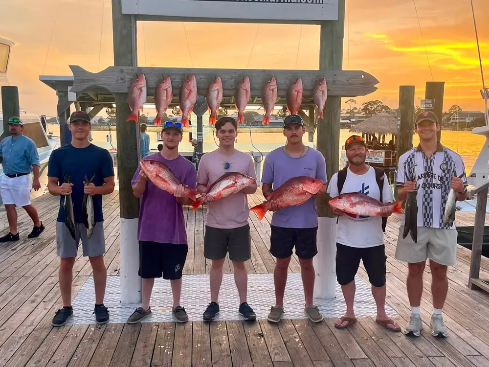 A charter group at the fish rack in golden evening light