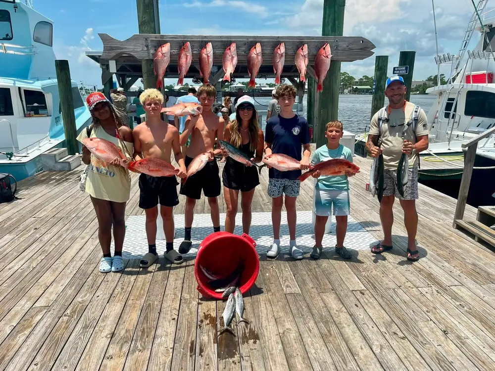 A charter party posing with the day's catch on the dock