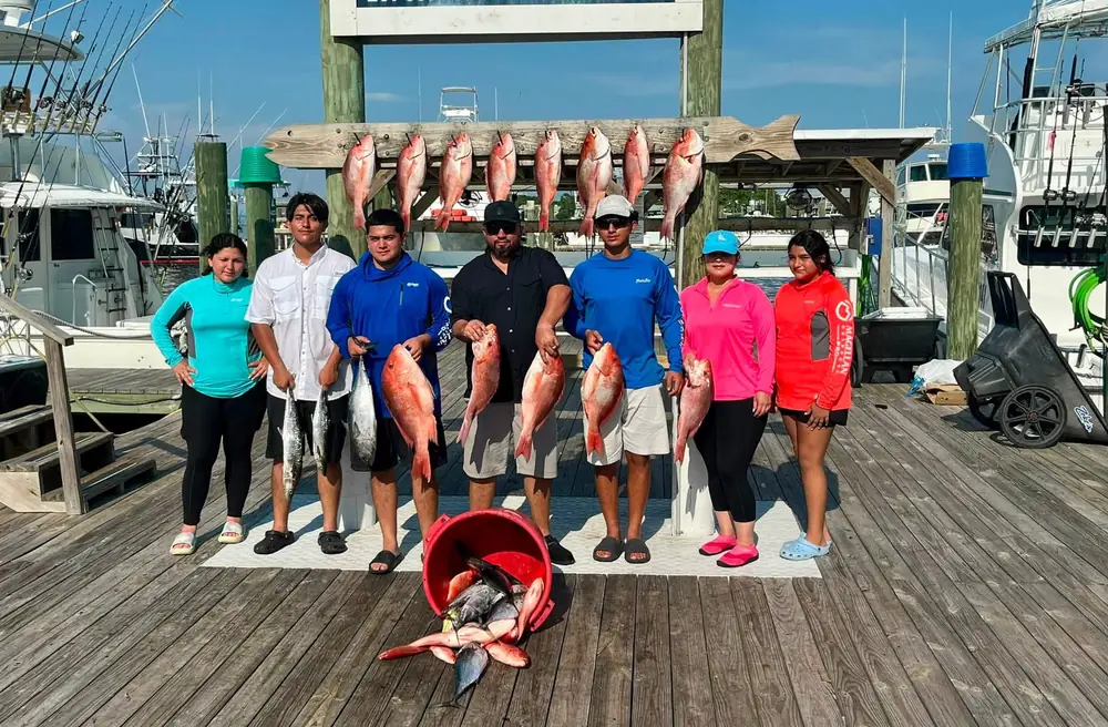 A charter group with their snapper haul at the marina